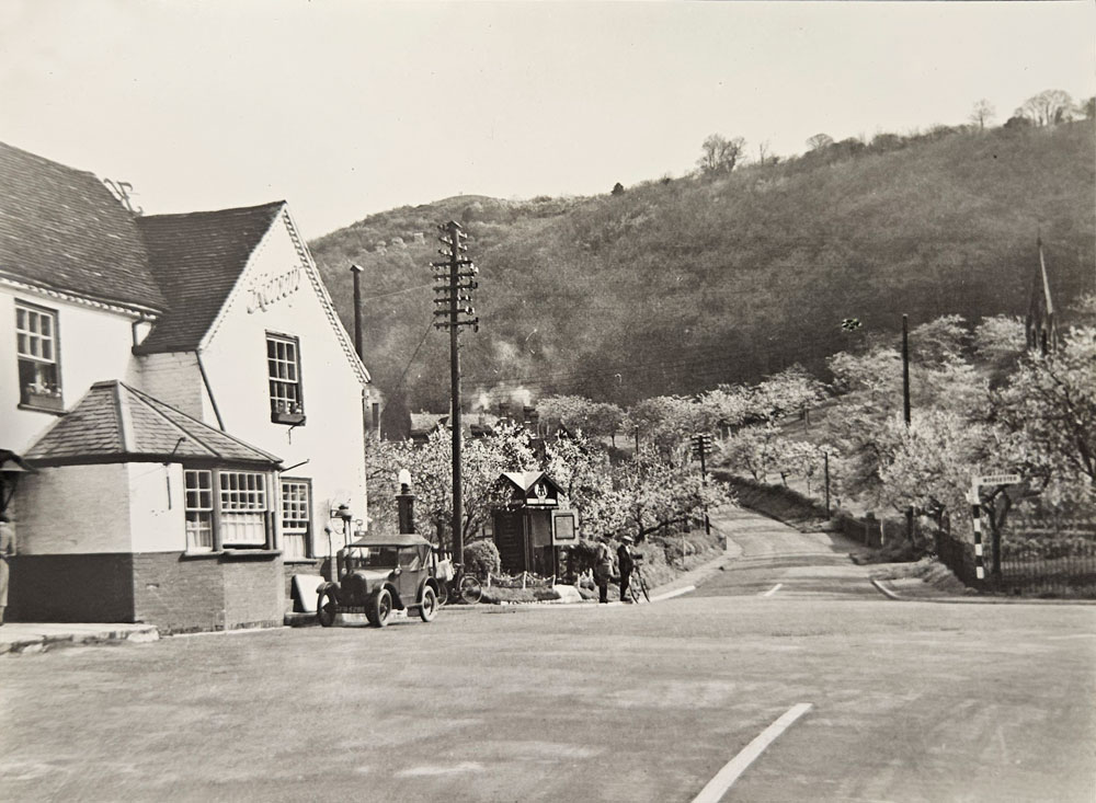 A wonderful old photograph showing the Talbot Hotel with its old porch entrance but better still the old AA box.